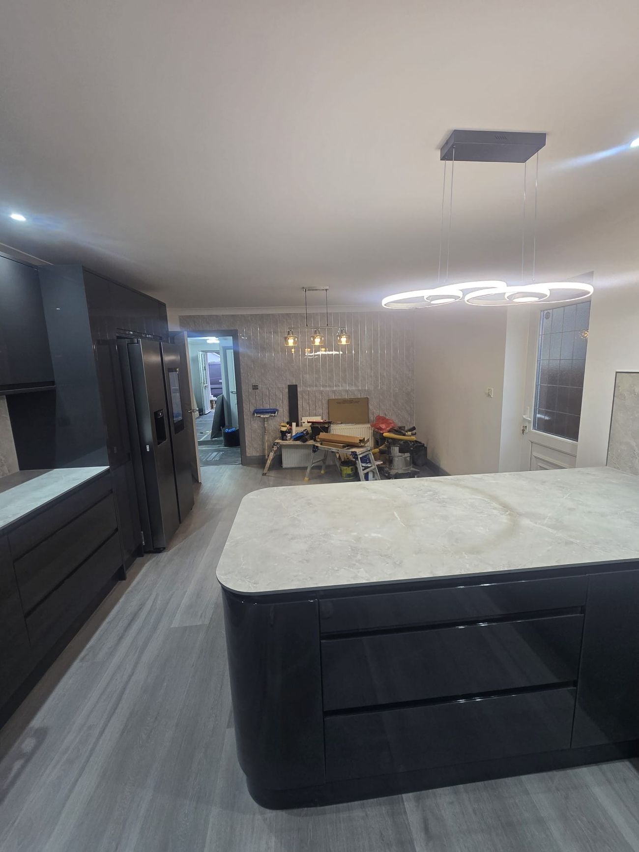 Kitchen island with stone worktop and feature lighting